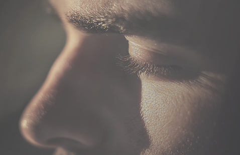 Close-up profile of a man with eyes closed, symbolizing deep relief, inner peace, and the absence of pain