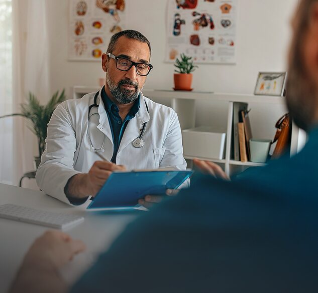 Doctor with glasses consulting with a patient in a medical office, symbolizing professional medical advice and trust